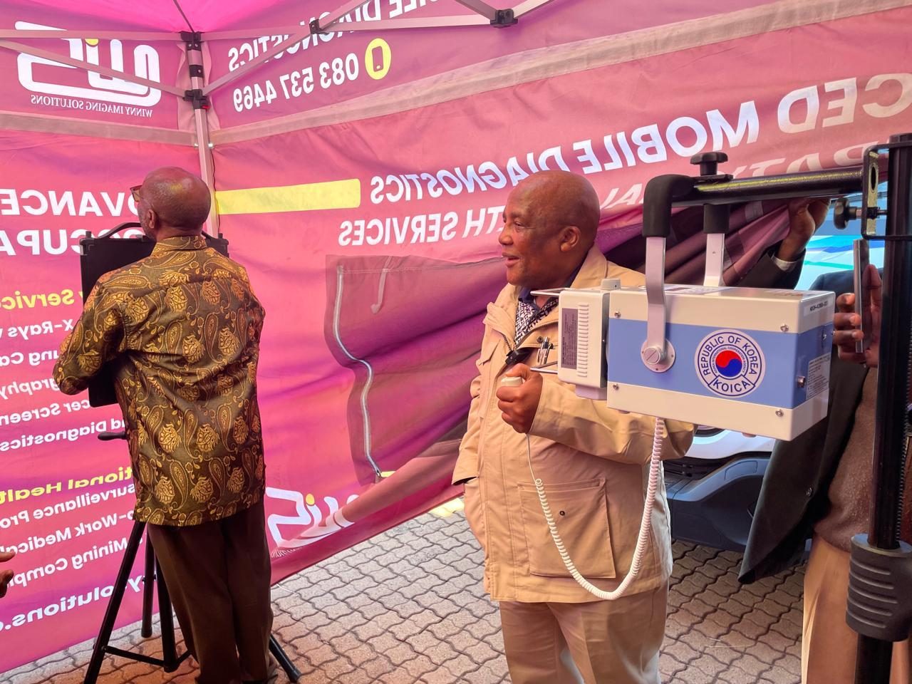 Health Minister Dr Aaron Motsoaledi with an ultra-portable digital X-ray unit at the Mafefe integrated health screening day, Limpopo