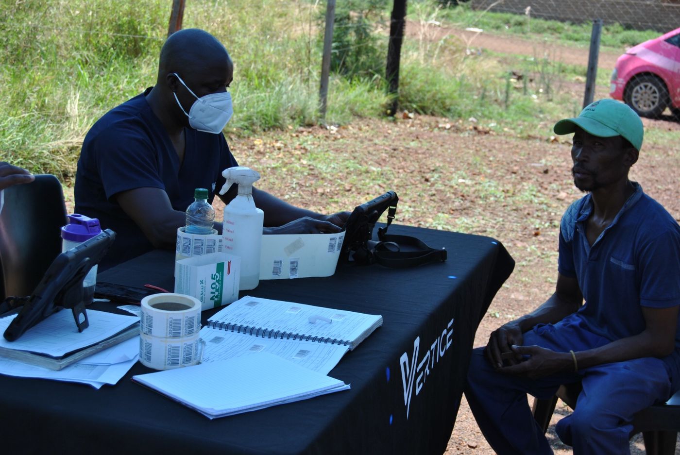 A Vertice Mobile Health clinician carrying out a screening assessment with a client at an outreach site
